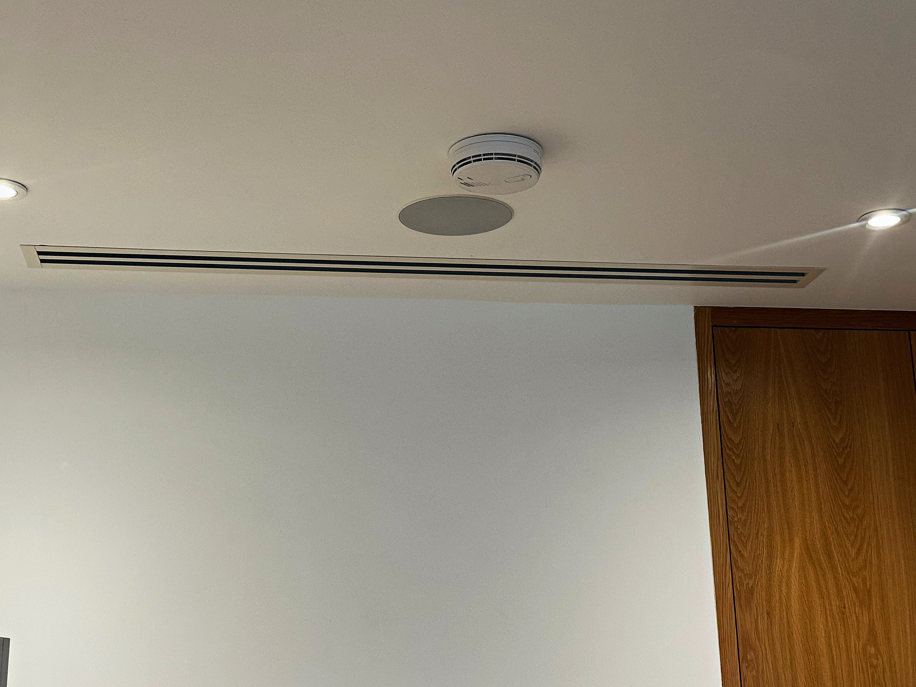 Slimline ducted grille set into the ceiling of a finished room