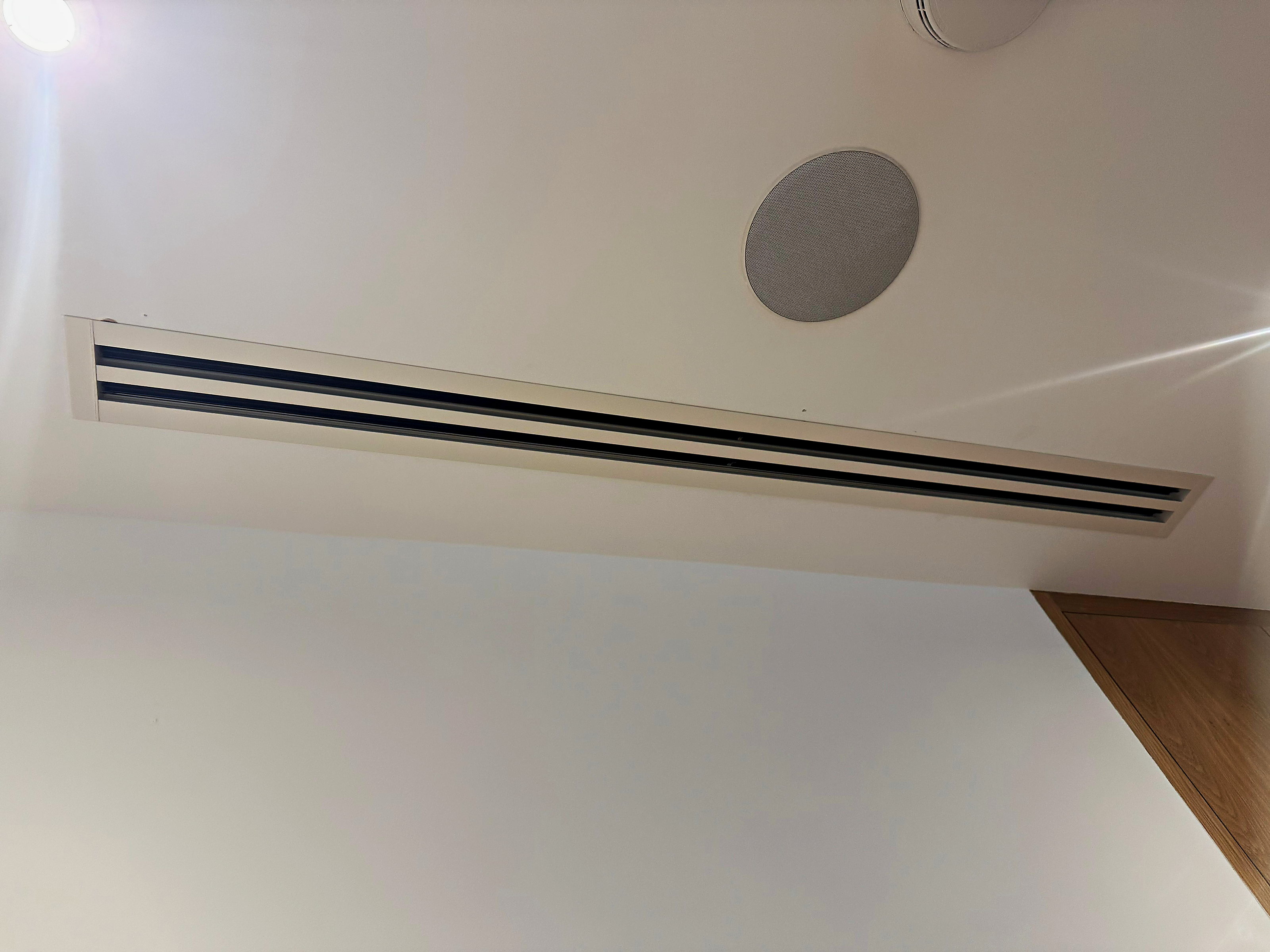 Slimline ducted grille set into the ceiling of a finished room