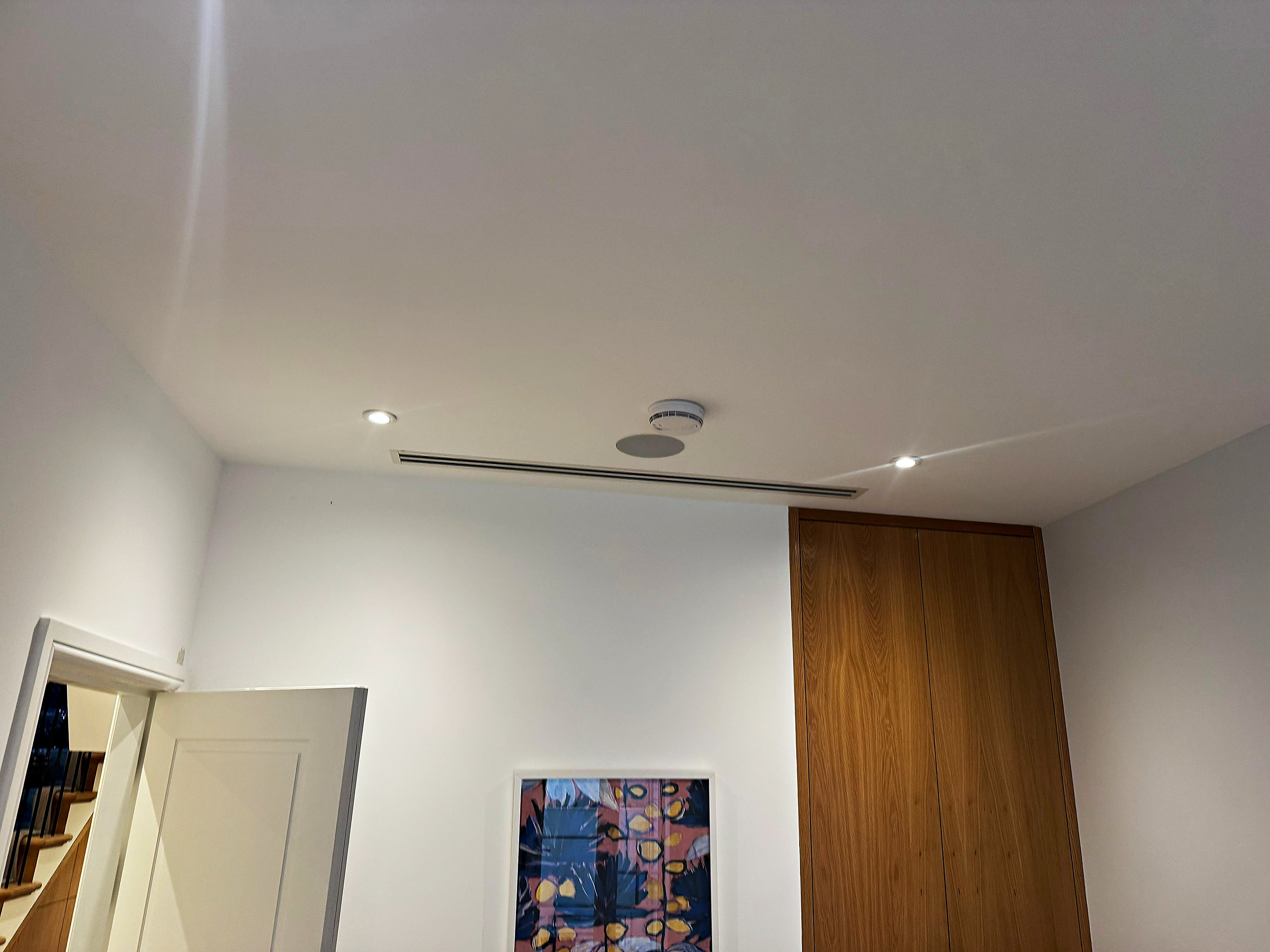Slimline ducted grille set into the ceiling of a finished room