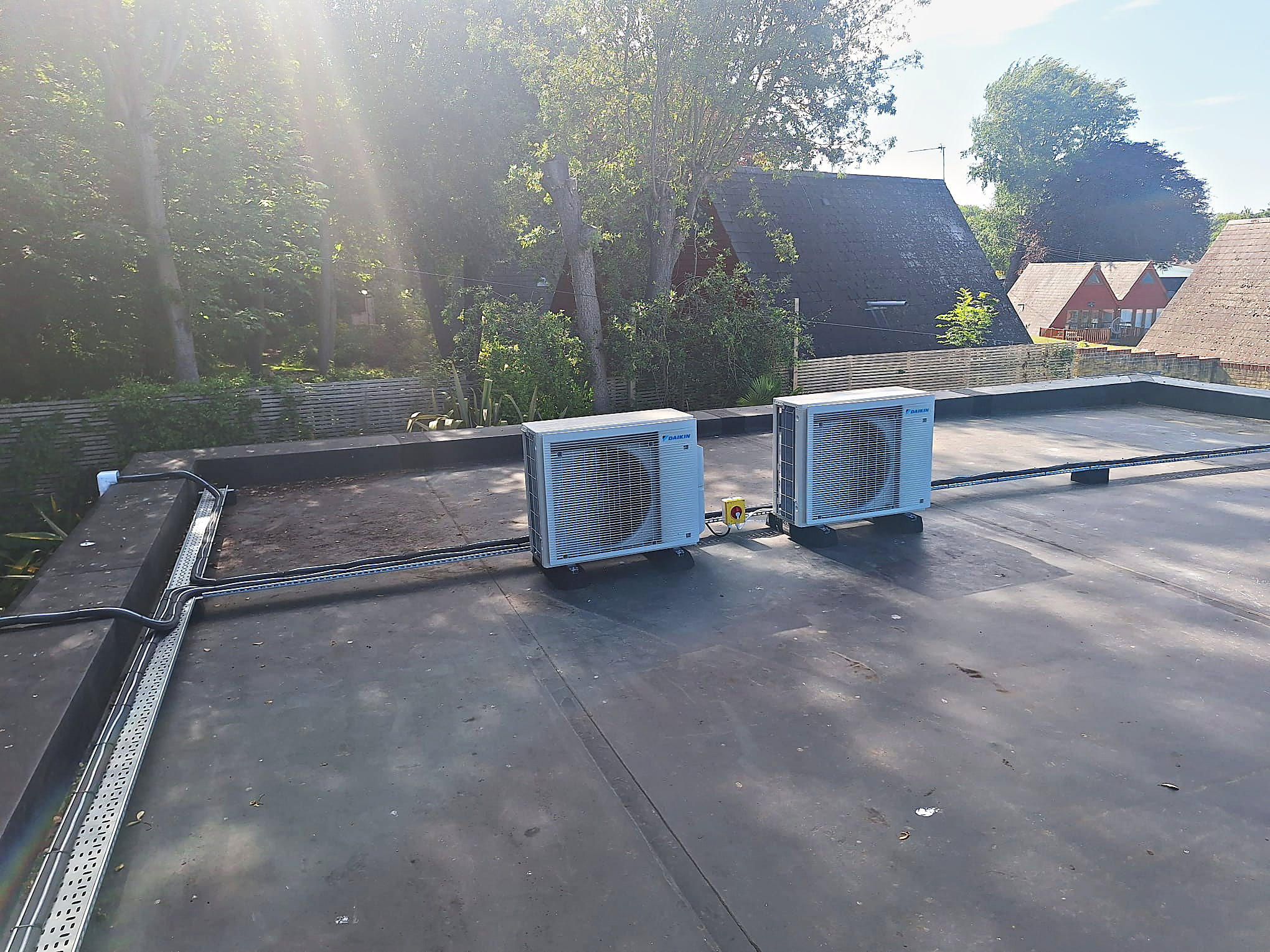 Daikin condenser units installed together on a flat roof