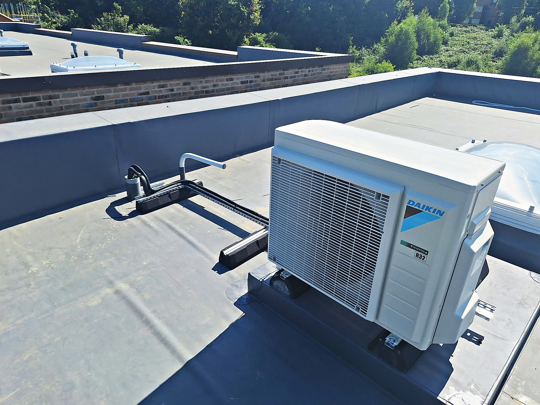 Daikin condenser units installed together on a flat roof