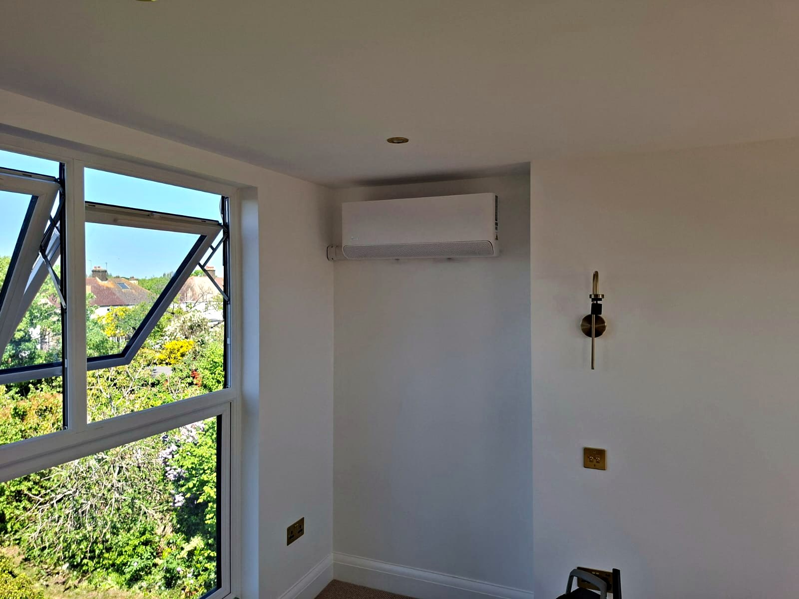 Wall mounted unit fitted high on the wall of a finished room