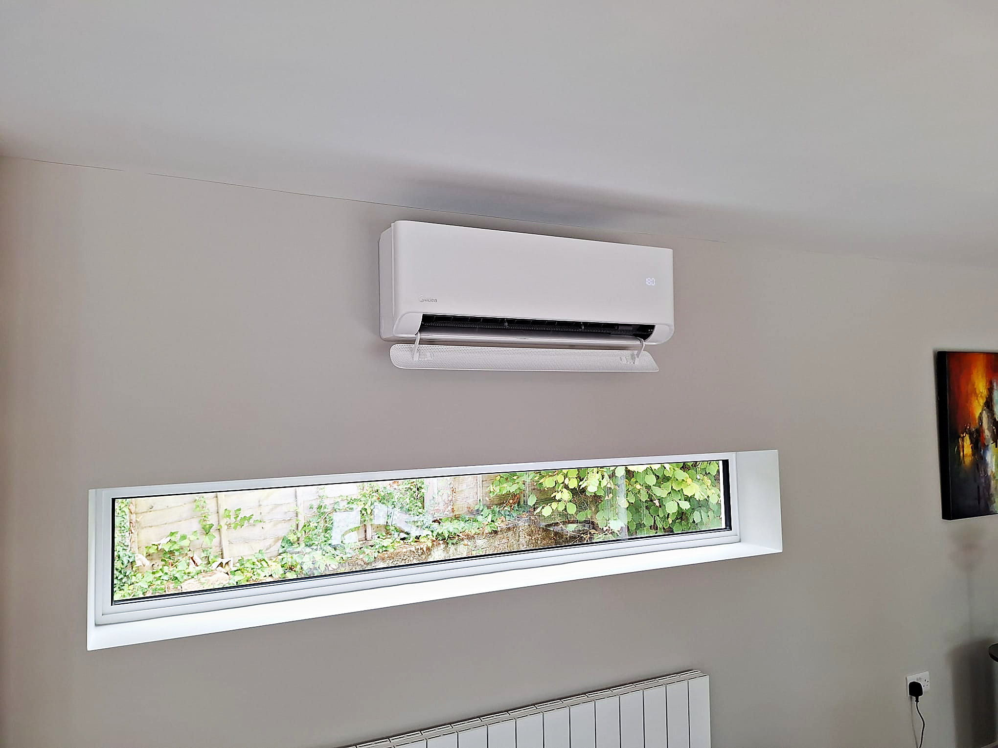 Wall mounted unit fitted high on the wall of a finished room