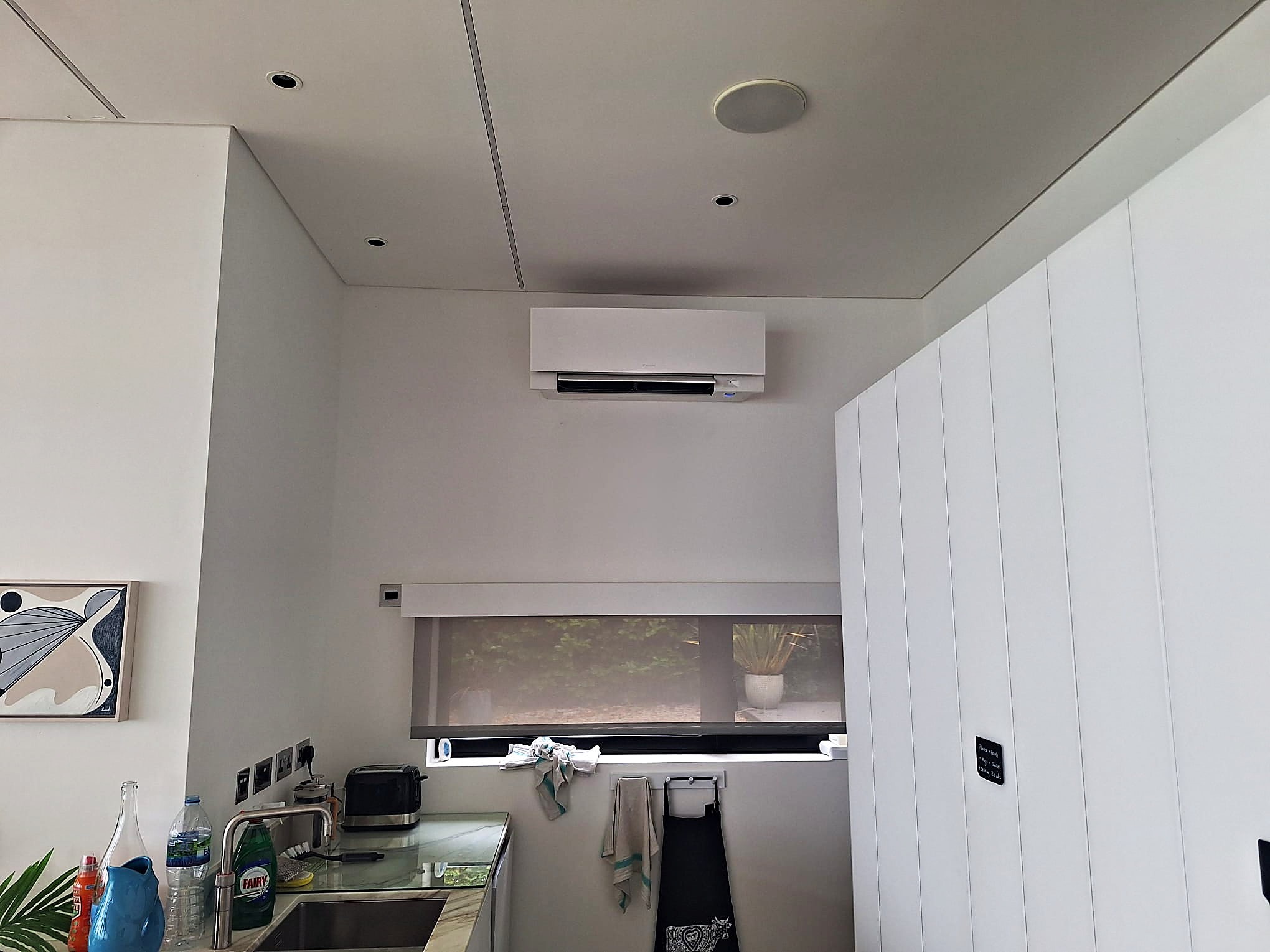 Wall mounted unit fitted high on the wall of a finished room