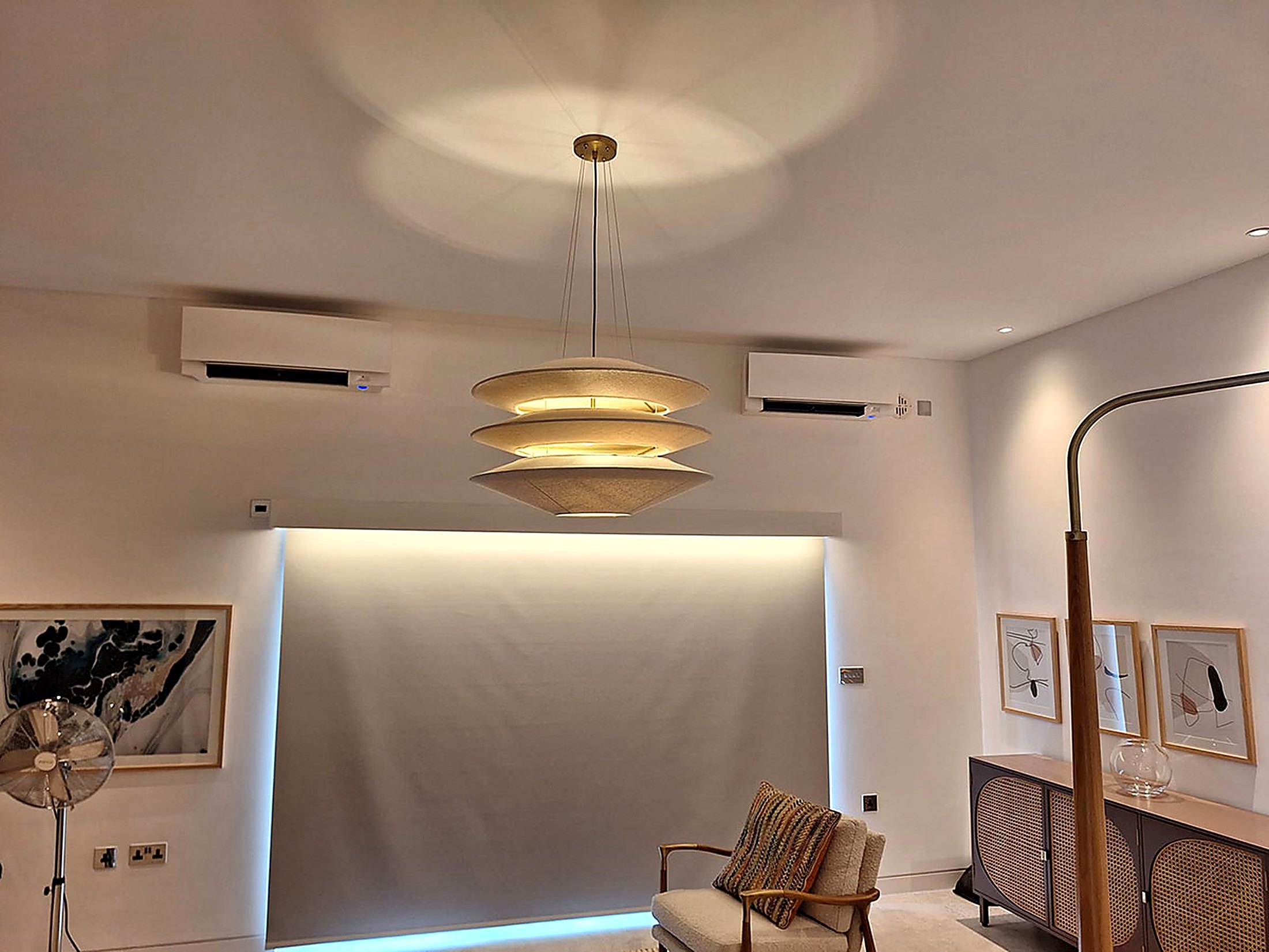 Living room with a designer pendant light and two ceiling level units