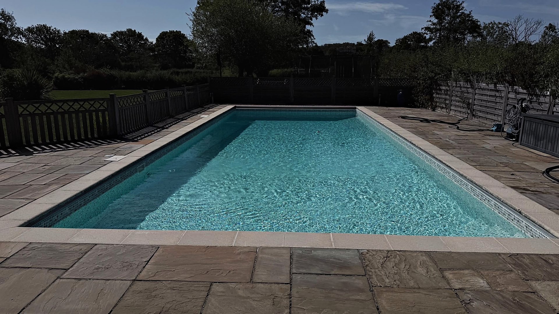 Outdoor swimming pool heated by a heat pump